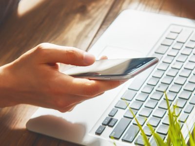 Man is using phone. Concept of young people are working with mobile devices, online shopping. Close up.